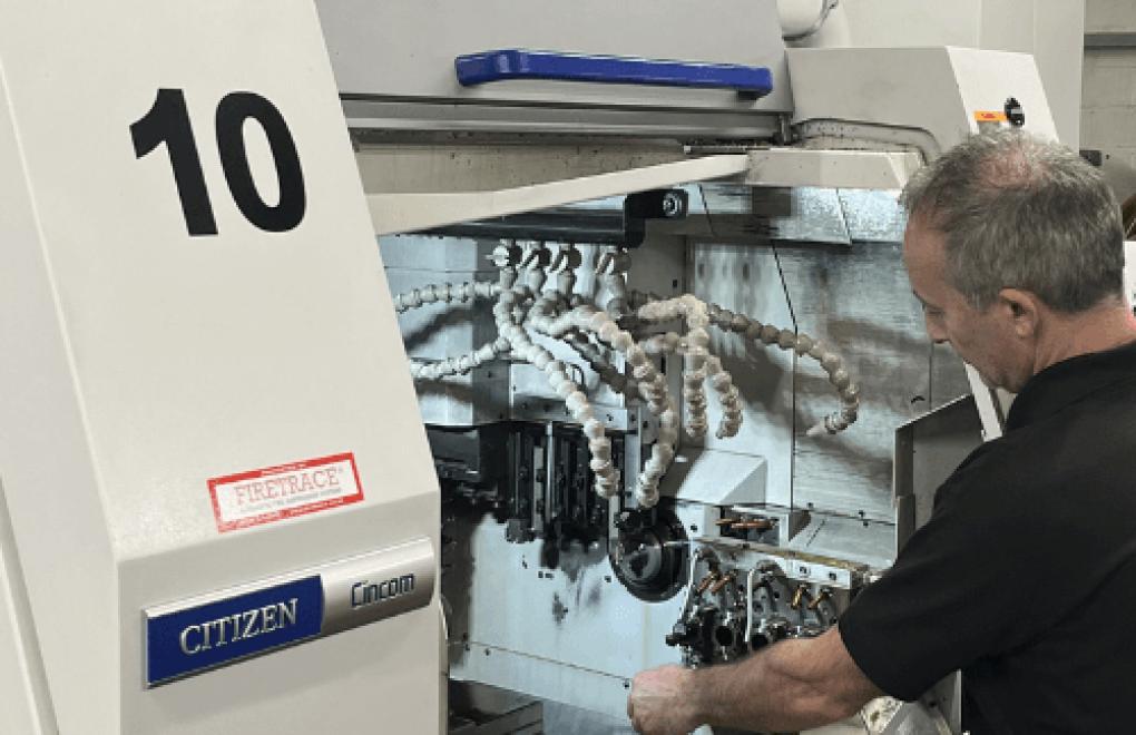 CNC sliding head lathe operator setting up a Citizen Cincom machine